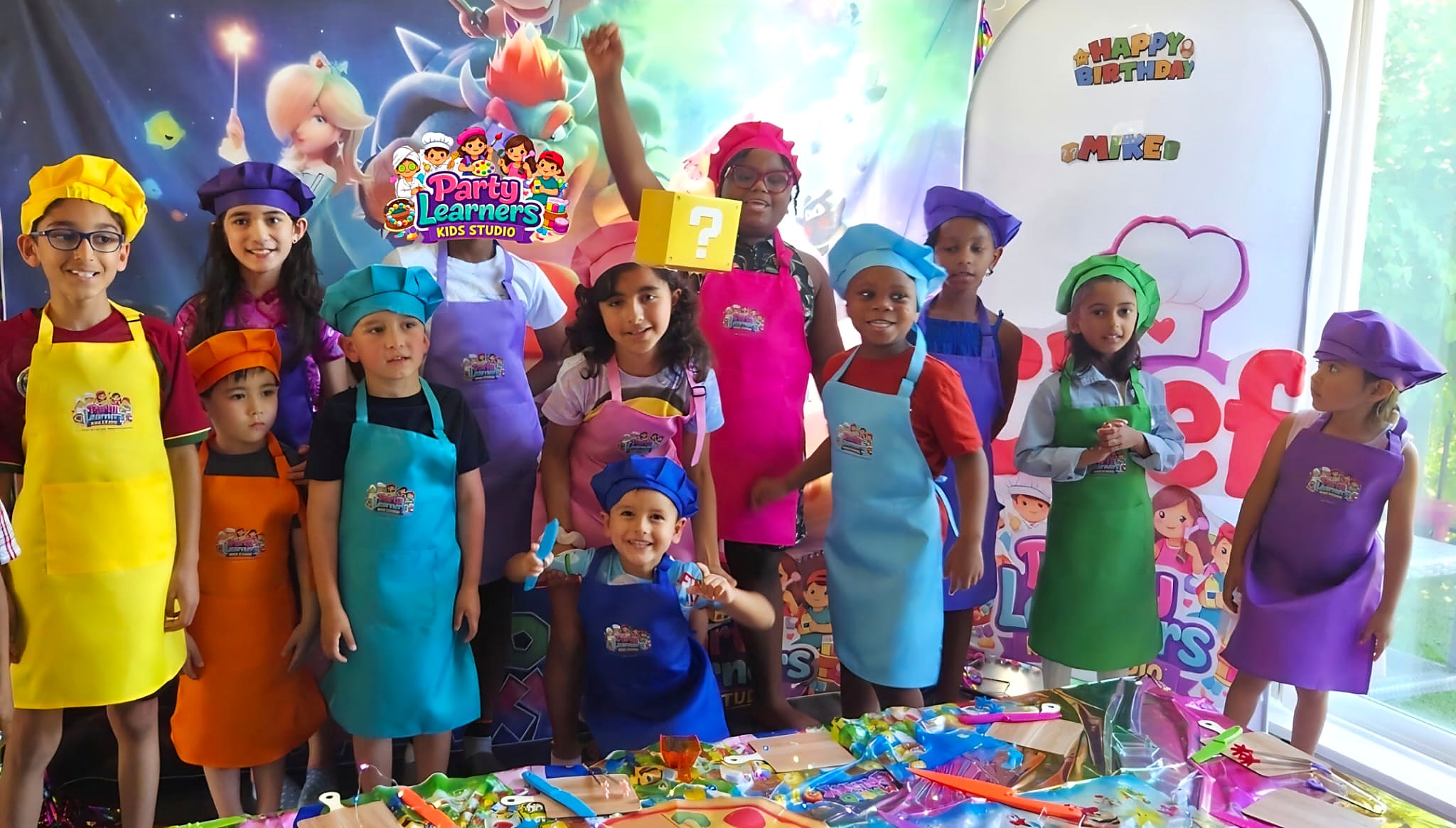 Kids in colorful chef hats and aprons at a Chef Party — Decorating Experience