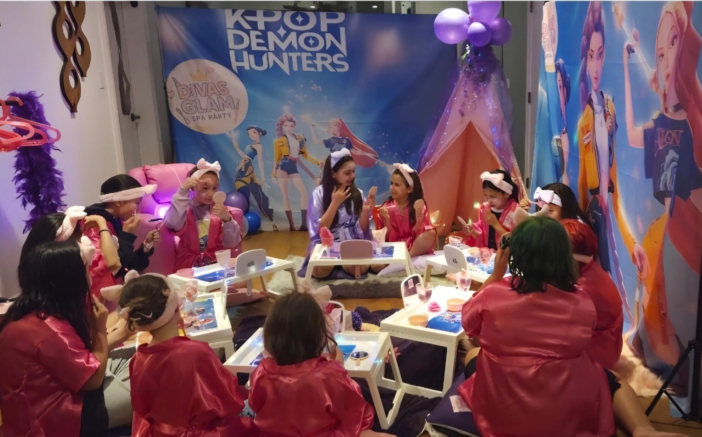 Wide group of girls celebrating a K-Pop themed Divas Glam Spa Party with balloons