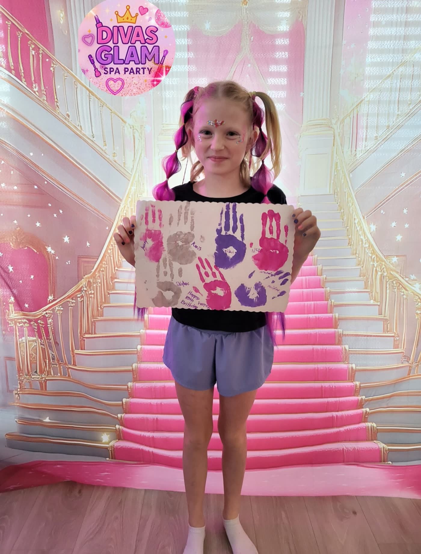 Birthday girl with the group handprint art keepsake from her Divas Glam Spa Party