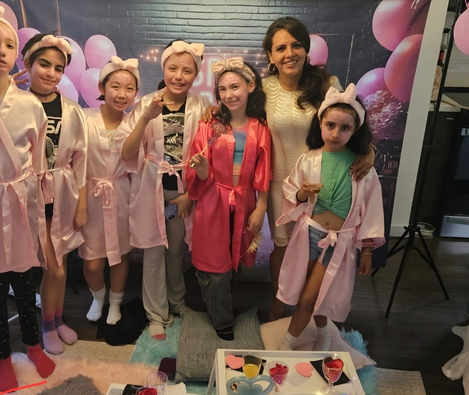 Group of girls in pink robes and bow headbands at a Divas Glam Spa Party with Party Learners host Jenn