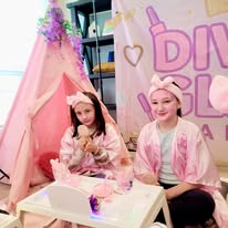 Mom and birthday girl in pink robes inside a Divas Glam Spa Party teepee setup