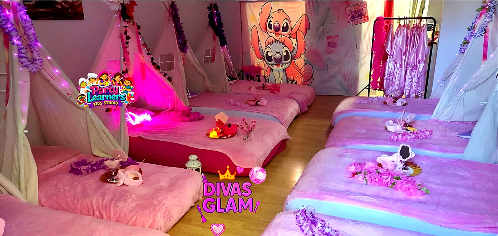 Slumber Party Teepee Setup with Angel & Stitch themed backdrop, pink teepees and ambient lighting