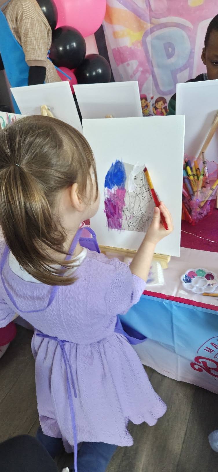 Girl painting a themed canvas at a Paint Boho Party