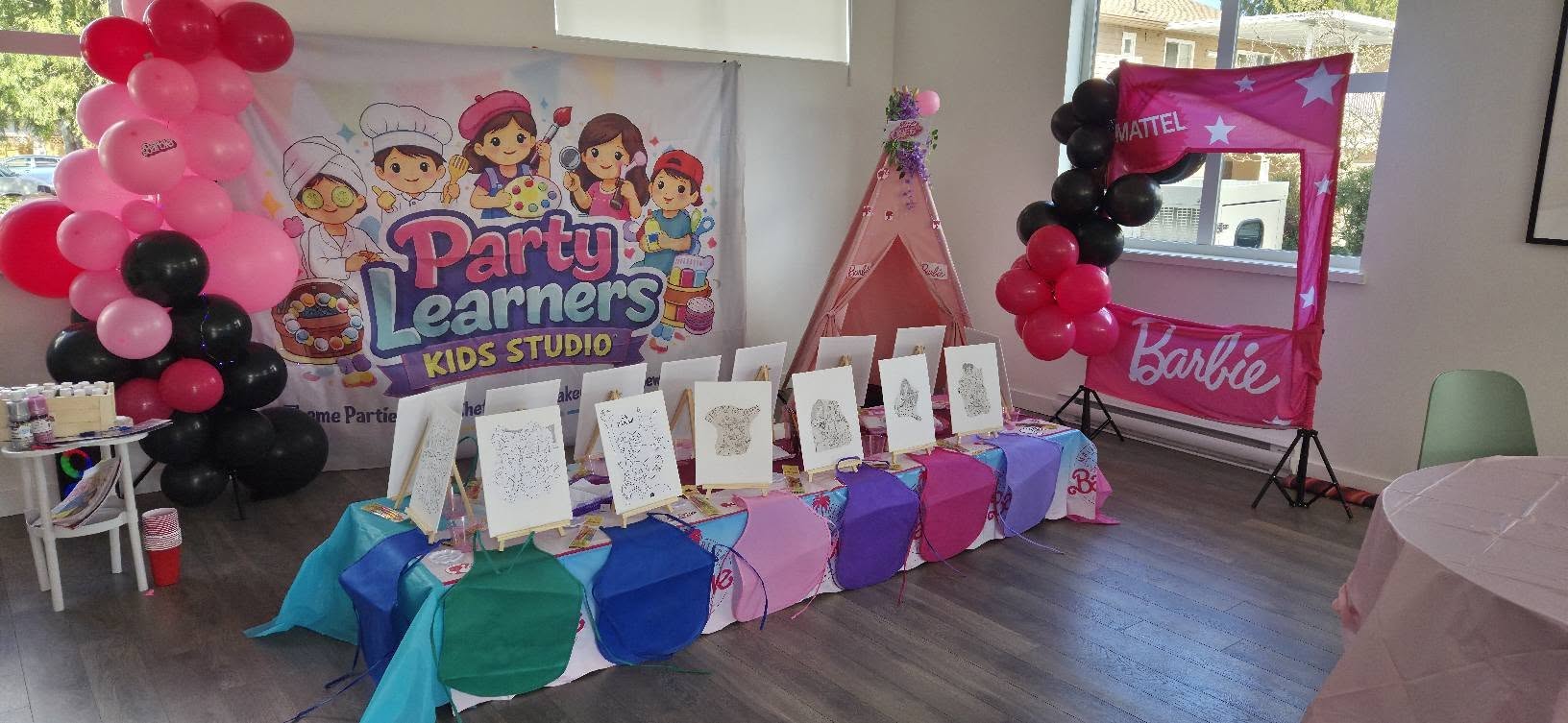 Paint Boho Party setup with Party Learners banner and easels