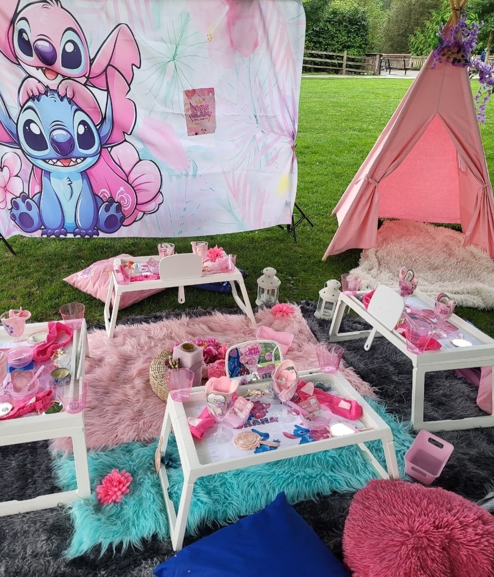 Angel and Stitch themed party setup outdoors with pink teepee and spa trays