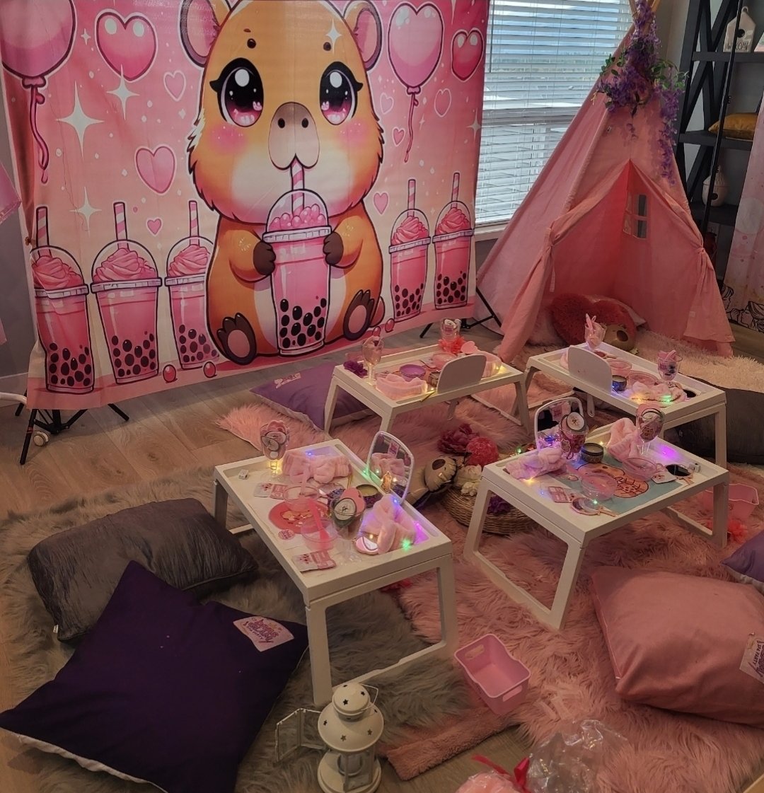 Capibara themed party setup with bubble tea backdrop, pink teepee and spa trays